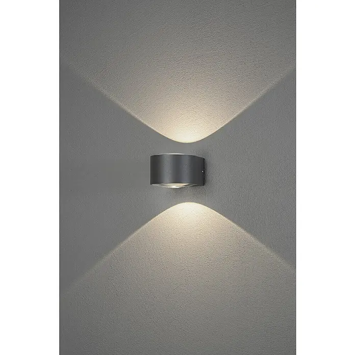 Konstsmide LED-Außenwandleuchte Gela - 12 W, 15,5 x 11 x 6,5 cm, Anthrazit, IP54 - Wandleuchte aus Metall mit zylindrischem Design. Die Leuchte strahlt nach oben und unten und erzeugt einen schönen Lichteffekt.