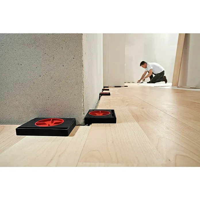 Bessey Abstandhalter - 4 Stk. - Bild von schwarzen, quadratischen Bodenabstandshaltern mit roten Details, die für eine gleichmäßige Dehnungsfuge an Wänden bei der Bodenverlegung sorgen.