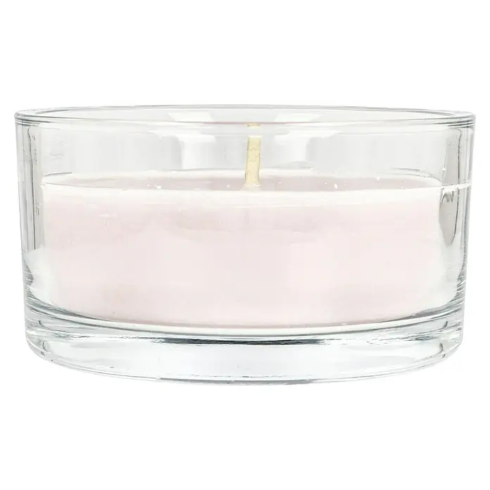 Outdoor-Kerze in Glasschale - Ø x H: 15 x 8 cm, Antikrosa - Nahaufnahme einer Kerze in einem transparenten Glasgefäß, die ein warmes, subtiles Leuchten verströmt und eine ruhige Atmosphäre suggeriert.