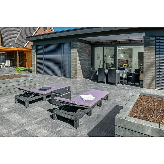 Diephaus Pflasterstein Lincoln - Quarzit, 60 x 30 x 8 cm, Rechteckig - Diese moderne Terrasse verfügt über graue Terrassenplatten, zwei Liegestühle mit lila Auflagen und einen Esstisch mit Stühlen. Die Terrasse lädt zum Verweilen ein.