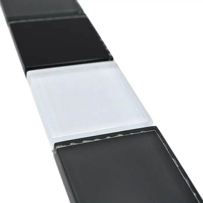 Fliesenbordüre Vision BO NB19481 - 4,8 x 30 cm, Mix Schwarz/Grau, Glänzend - Nahaufnahme von schwarzen und weißen quadratischen Glasmosaikfliesen für Wandverkleidungen, ideal für Küche und Bad.