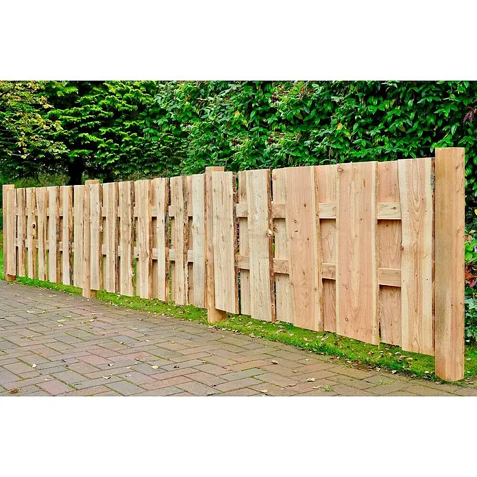 T & J Sichtschutzelement Jütland - B x H: 180 x 90 cm, Natur - Hölzerner Gartenzaun aus naturbelassenem Holz, der sich durch eine grüne Rasenfläche und einen gepflasterten Weg schlängelt.