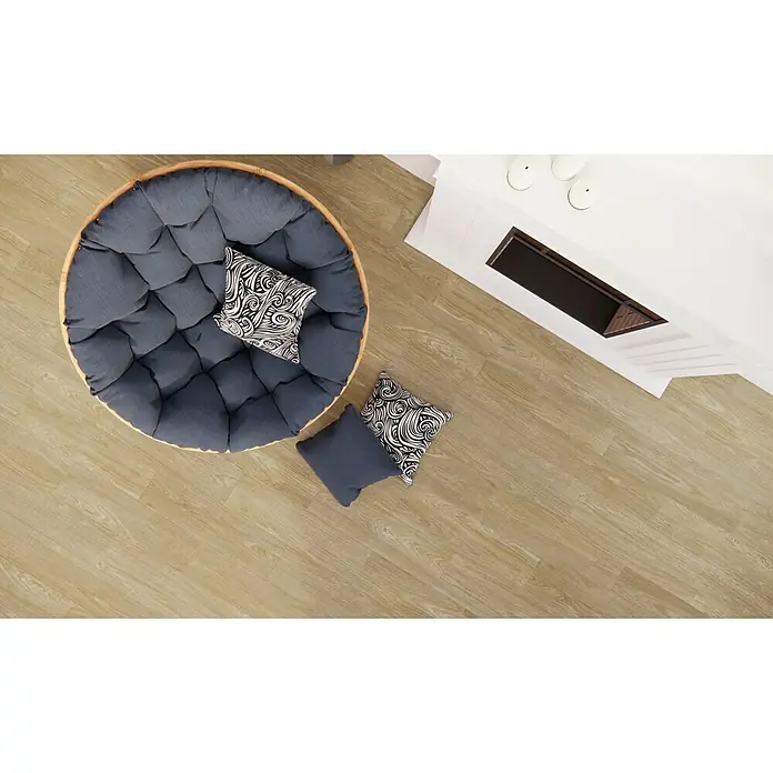 Pavimento porcelánico Alcázar - 20 x 75 cm, Nut, Mate - Una cómoda silla papasan con cojines y elementos decorativos en un suelo de madera clara, junto a una chimenea blanca.