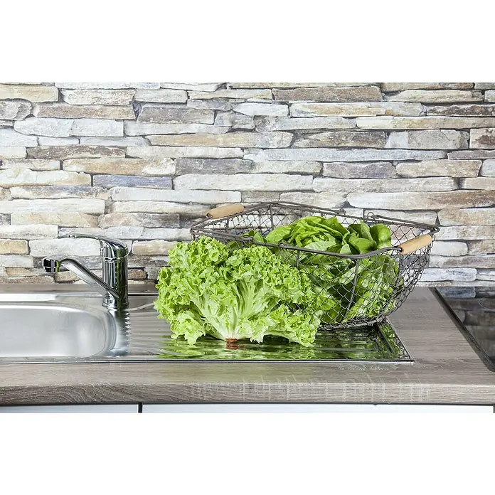 Piardino Pflücksalat Bio - Lactuca sativa var. crispa, Erntezeit: April - Frischer Salat in einem Drahtkorb neben einer Spüle, bereit für eine gesunde Mahlzeit.