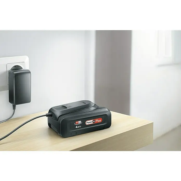 Bosch Power for All 18V Akku PBA Power Plus - 18 V, 4 Ah - Ein schwarzer Bosch Power Plus 4.0 Ah Akku wird mit einem Ladegerät auf einem hellen Tisch aufgeladen.