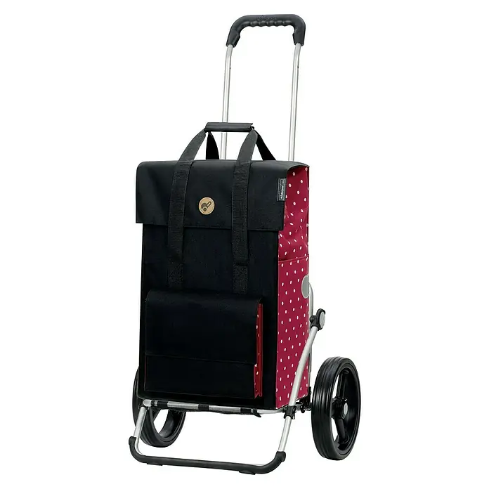 Andersen Royal Einkaufstrolley Janne - Traglast: 50 kg, Schwarz/Rot - Das Bild zeigt einen Andersen Shopper Manufaktur Trolley mit einem schwarzen, rot gepunkteten Design und robusten Rädern.
