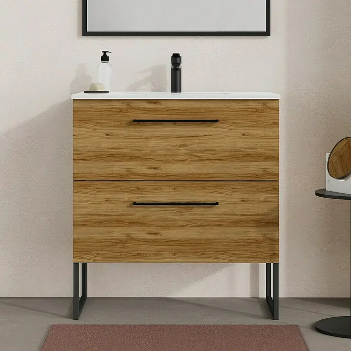 Artysan Mueble bajo de lavabo Arosa - L x An x Al: 44,6 x 80 x 64 cm, Roble Guadarrama - Un moderno mueble de lavabo con aspecto de madera con dos cajones, una encimera blanca y elegantes tiradores negros.