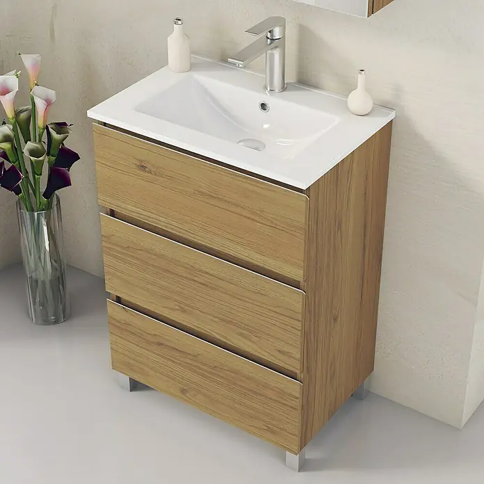 Artysan Mueble bajo de lavabo Ons - L x An x Al: 38,6 x 60 x 83,3 cm, Roble Guadarrama - Un elegante mueble de lavabo con aspecto de madera con tres cajones, una encimera blanca y un grifo moderno, perfecto para cualquier baño contemporáneo.
