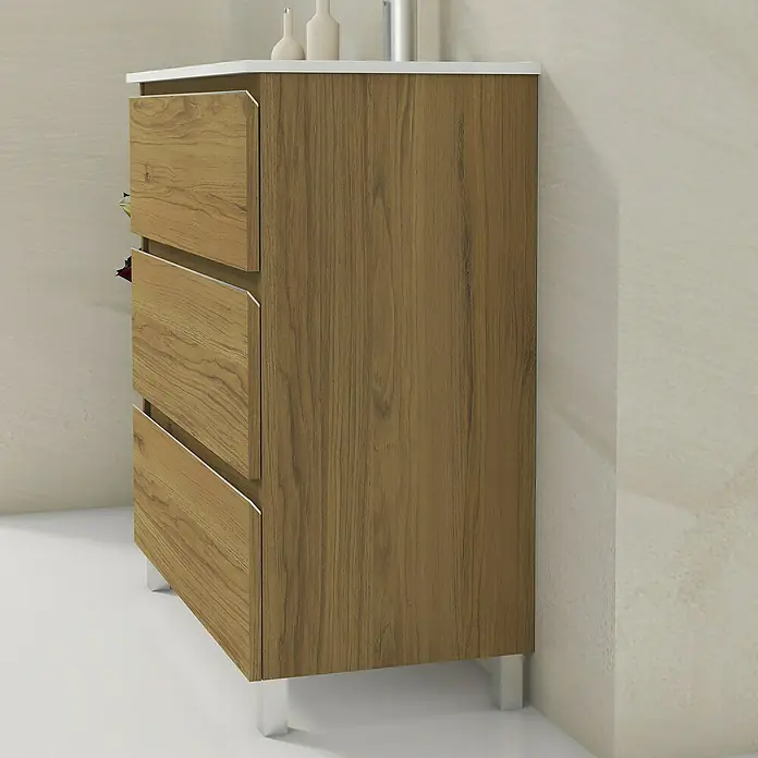 Artysan Mueble bajo de lavabo Ons - L x An x Al: 38,6 x 80 x 83,3 cm, Roble Guadarrama - Una cómoda de madera moderna con tres cajones y patas plateadas. El mueble está colocado contra una pared clara.
