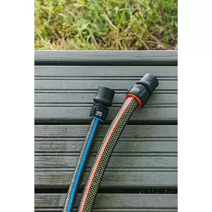 Fiskars FiberComp Schlauchanschluss - ¾″ - Zwei Gartenschläuche mit schwarzen FiberComp-Anschlüssen, blauem und orangefarbenem Streifen, auf Holzuntergrund.