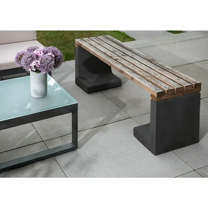Diephaus L-Stein - 80 cm, 50 cm, Stärke: 7 cm, Anthrazit - Moderne Gartenszene mit Holzsitzbank auf Betonfüßen und Glastisch mit Blumen, die das schlichte Design im Außenbereich ergänzen.