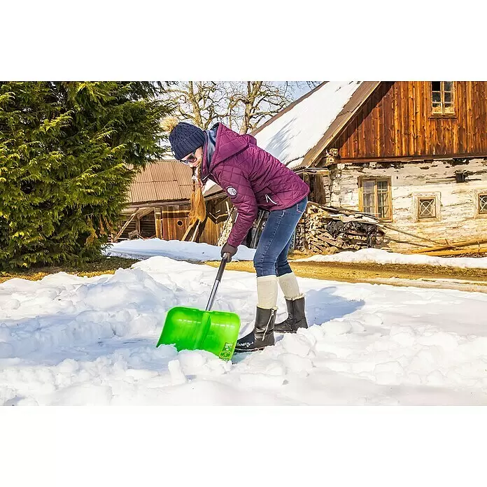 Freund Victoria Kunststoff-Schneeschaufel - Breite: 40 cm, Material Stiel: Aluminium - Eine Person nutzt eine grüne Schneeschaufel, um Schnee in winterlicher Umgebung zu räumen.