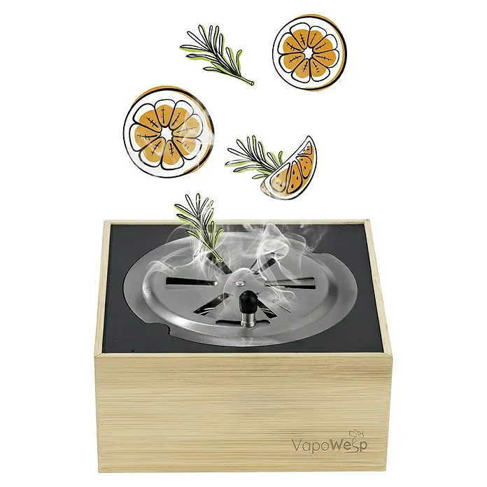 VapoWesp Räucherpulver - Orange & Rosemary, 100 g - Produktbild eines VapoWesp-Aromaverdampfers mit Zitrusfrüchten und Kräutern, der aromatischen Dampf erzeugt.
