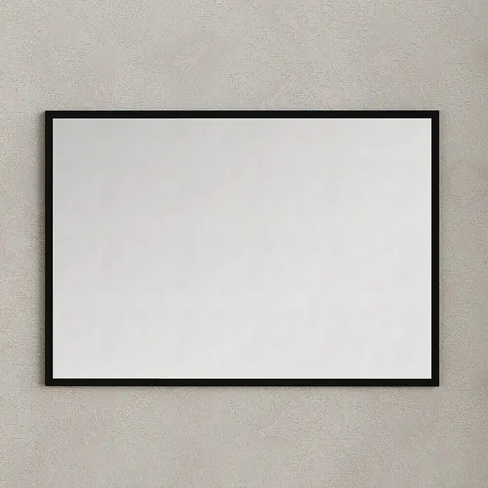 Artysan Espejo con marco Arosa - 100 x 80 cm, Negro - Un espejo rectangular con un marco negro sencillo está montado en una pared gris, reflejando una luz difusa. Las líneas limpias ofrecen un toque moderno.