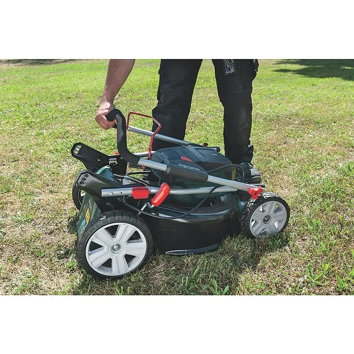 Metabo CAS 18V Akku-Rasenmäher RM 36-18 LTX BL 46 - 18 V, Ohne Akku, 5,2 Ah, Schnittbreite: 46 cm - Nahaufnahme eines Mannes, der einen Metabo Rasenmäher auf einer Rasenfläche zusammenklappt, um ihn zu verstauen.