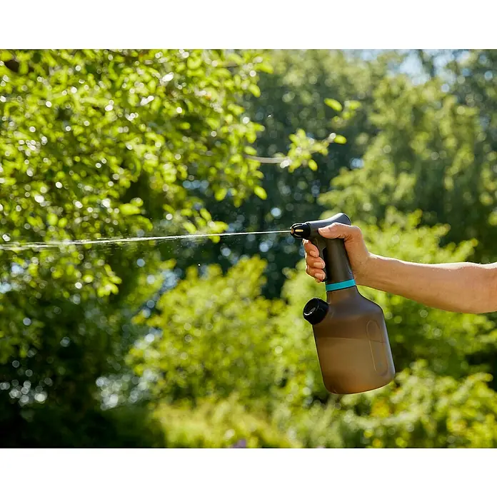 Gardena Handsprüher - 1 l - Eine Person sprüht mit einer GARDENA Druckspritze Pflanzen im Garten. Das Gerät liegt gut in der Hand und ist einfach zu bedienen.