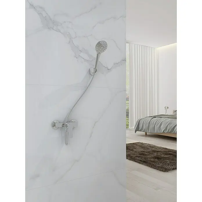 IO Rhio Grifo monomando de ducha - Cromo - Un cabezal de ducha cromado brillante sobre una pared de mármol blanco, combinando estilo moderno y funcionalidad en el baño.