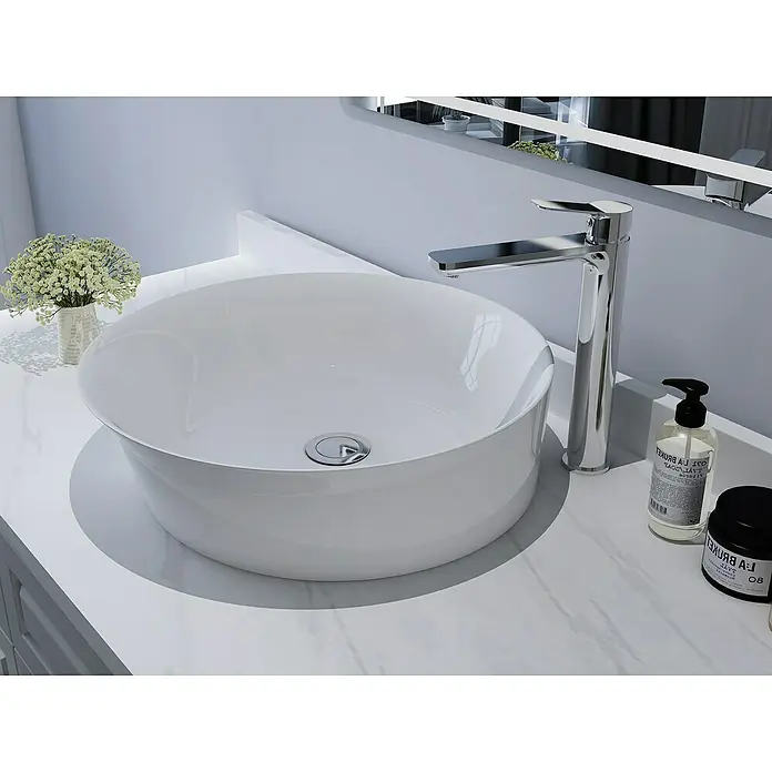 IO Rhio Grifo de lavabo alto - Cromo - Primer plano de un baño moderno con un elegante lavabo redondo y accesorios sobre una encimera de mármol.