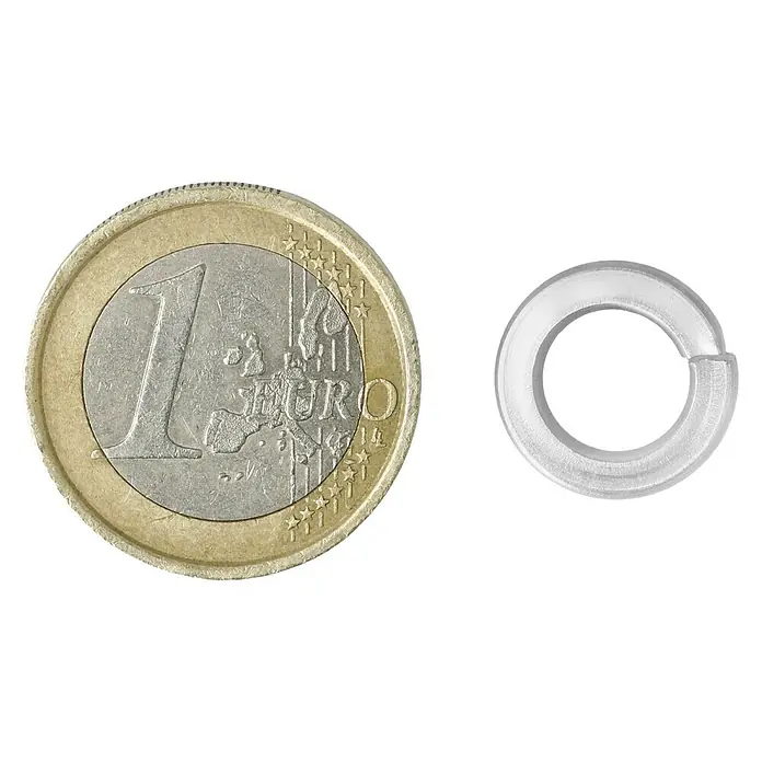 Federring A2 - Innendurchmesser: 8,1 mm, Edelstahl, 8 Stk. - Eine Unterlegscheibe aus Stahl liegt neben einer 1-Euro-Münze, was einen Größenvergleich ermöglicht.