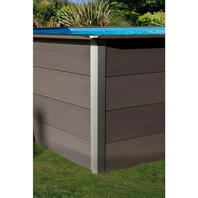 Gre Avantgarde WPC-Pool Avantgarde - L x B x H: 804 x 386 x 124 cm, 27.000 l, Dunkelgrau - Nahaufnahme des Eckbereichs eines Holzpools mit silbernen Eckverbindungen, umgeben von Rasen und Vegetation.