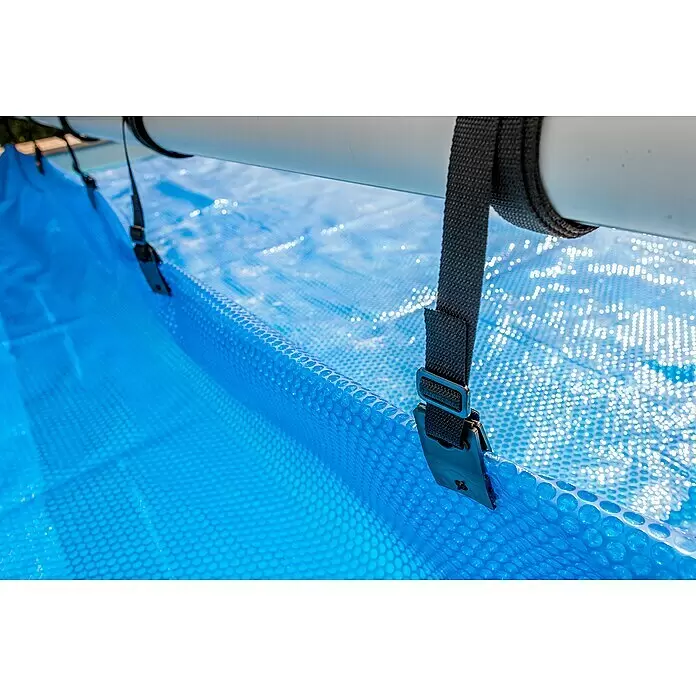 Gre Planenaufroller - Passend für: Pools bis 500 cm Breite - Blaue Solar-Poolabdeckung mit Blasenstruktur, an einer weißen Rollenstange mit schwarzen Gurten befestigt.