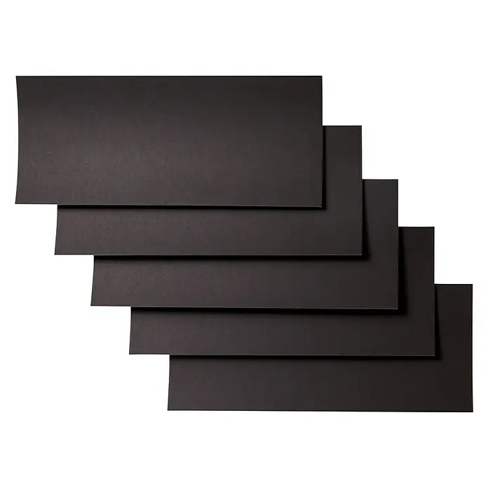 Cricut Joy Aufkleber Smart Paper Sticker Cardstock - 10 Stk., Schwarz, 30 x 14 cm - Mehrere rechteckige, schwarze Blätter liegen überlappend übereinander und bilden ein Treppenmuster vor einem schwarzen Hintergrund.