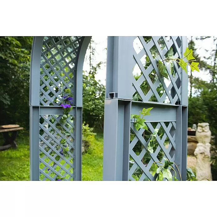 KHW Rosenbogen - Grau, 100 x 43 x 207 cm - Grauer modularer Gartenbogen mit Rankgittern, mit grünen Ranken und lila Blüten für Kletterpflanzen geschmückt.