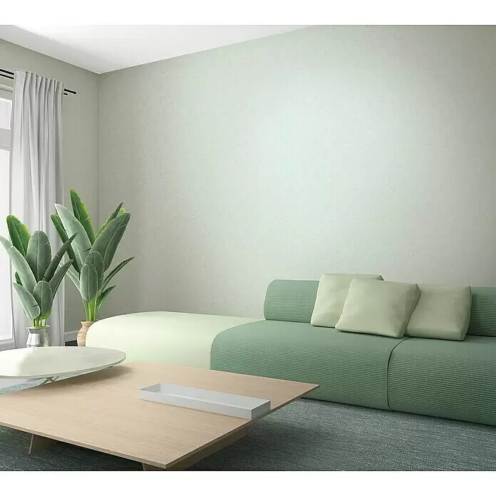 Marburg Kids' Walls Vliestapete schattiert - Beigegrau, Uni, 10,05 x 0,53 m - Ein modernes Wohnzimmer mit einem modularen Sofa in Grün und Hellgrün, einem hellen Holztisch und großen Pflanzen.
