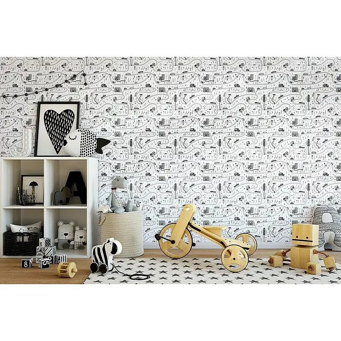 Marburg Kids' Walls Vliestapete Straßenführung - Weiß/Grau, Grafisch, 10,05 x 0,53 m - Kinderzimmer mit einer weißen Spielzeugkiste, einem Holzfahrrad und einer verspielten Tapete.