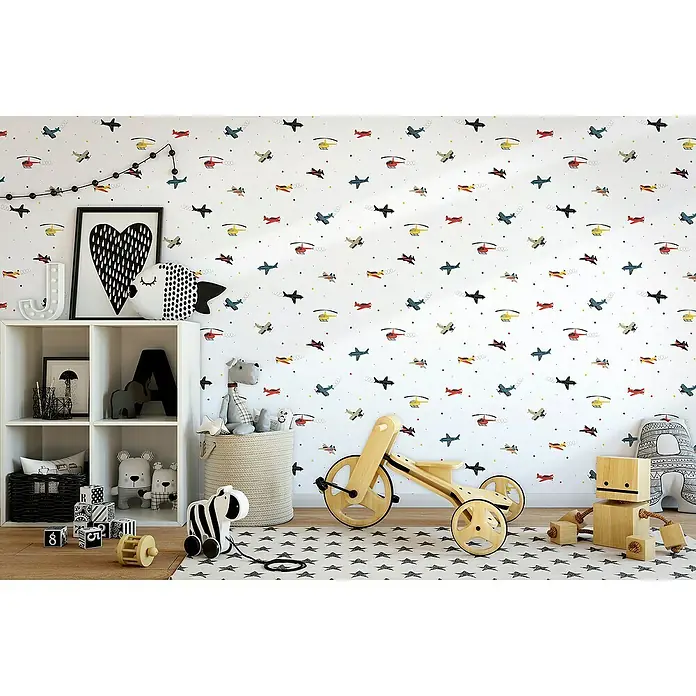 Marburg Kids' Walls Vliestapete Flugzeuge - Weiß/Multicolor, Grafisch, 10,05 x 0,53 m - Kinderzimmer mit Spielzeug und weißem Regal mit Flugzeugtapete.