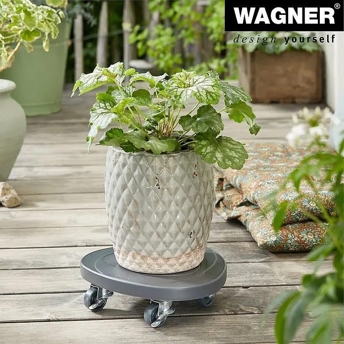 Wagner System Pflanzenroller - 28 cm, Beton, Anthrazit, Max. Belastung: 80 kg - Pflanzroller von Wagner mit einer Topfpflanze auf einer Holzterrasse, ideal für den flexiblen Einsatz im Garten.