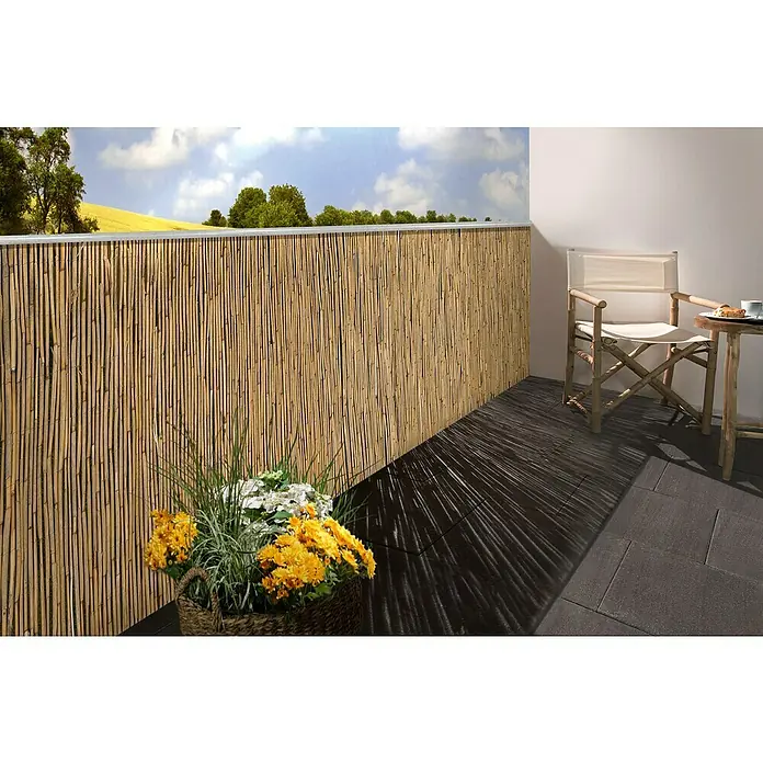 Gardol Schilfrohrmatte - 600 x 180 cm, Geeignet für: Sicht- und Windschutz - Blick auf einen Balkon mit einer Bambusmatte als Sichtschutz, einem Stuhl und einem kleinen Tisch mit Getränken.