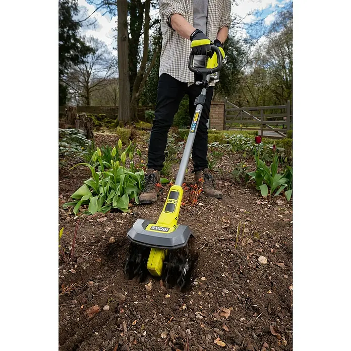 Ryobi ONE+ Akku-Bodenhacke RY18CVA-0 - Ohne Akku, Li-Ionen, 18 V - Ein Mann benutzt einen Ryobi ONE+ Akku-Bodenkrümler im Garten, um den Boden für die Bepflanzung vorzubereiten.