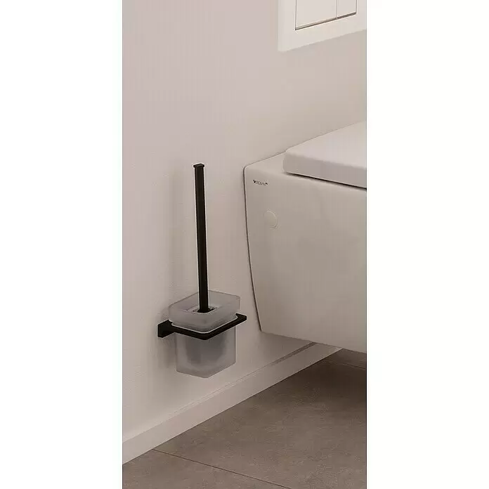 Phoenix WC-Bürstengarnitur - Metall, Schwarz - Schwarze wandmontierte Toilettenbürste mit mattem Glashalter neben einer weißen Toilette.