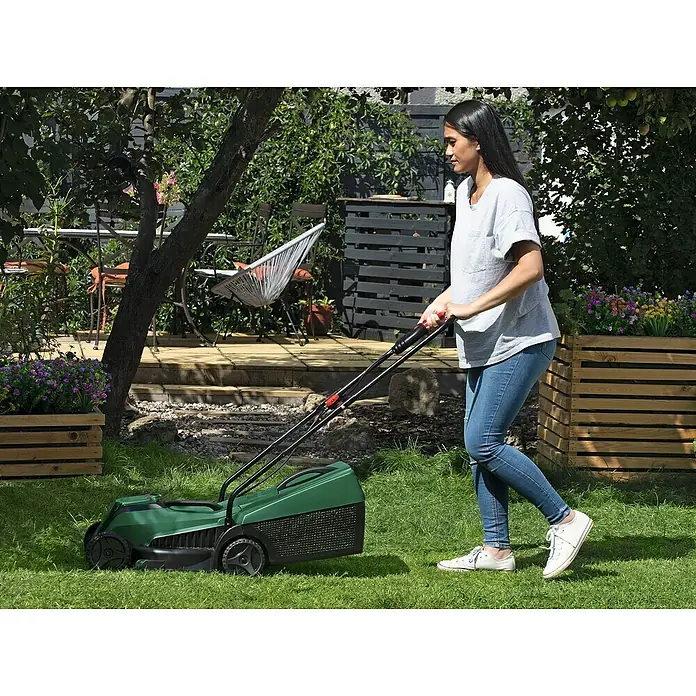 Bosch Power for All 18V Akku-Rasenmäher EasyMower 18V-32-200 - 18 V, Ohne Akku, Schnittbreite: 32 cm - Frau benutzt einen grünen Rasenmäher im Garten, um das Gras zu schneiden. Das Gerät ist gut erkennbar.