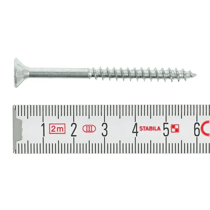 Profi Depot Spanplattenschraube VZ - Ø x L: 5 x 60 mm, 200 Stk., Verzinkt - Nahaufnahme einer Senkkopfschraube aus Stahl neben einem Zollstock zur Größenmessung.