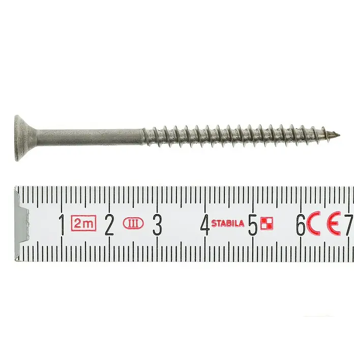 Profi Depot Spanplattenschraube A2 - Durchmesser: 5 mm, Länge: 70 mm, Edelstahl, TX für TORX-Antriebe, Teilgewinde, 100 Stk. - Ein silberfarbener Holzschraube liegt neben einem Zollstock, dessen Messbereich von 1 cm bis 7 cm reicht.