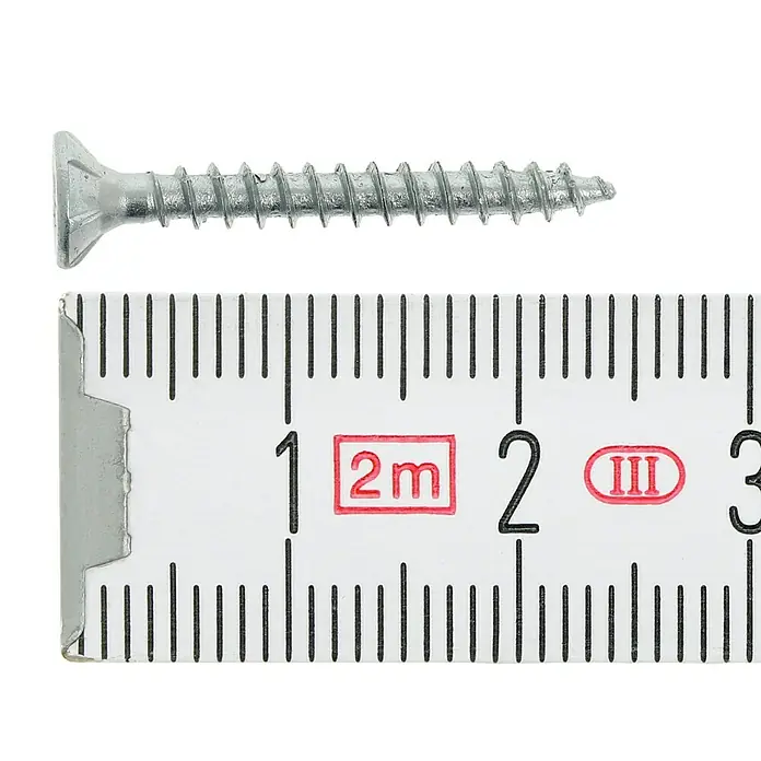 Profi Depot Tornillo para madera - Ø x L: 3 x 25 mm, 200 ud., Zincado, Ranura en forma de cruz Pozidriv - Un tornillo de cabeza avellanada plateado medido con una regla muestra una longitud de aproximadamente 2,8 cm. Ideal para bricolaje.