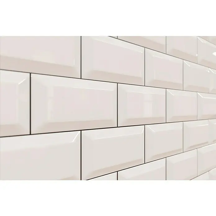 Modern Style Wandfliese Manhattan Biselado Blanco - 7,5 x 15 cm, Weiß, Glänzend - Nahaufnahme von glänzenden, cremefarbenen U-Bahn-Fliesen mit dunklem Fugenmörtel, die ein sauberes und modernes Erscheinungsbild verleihen.