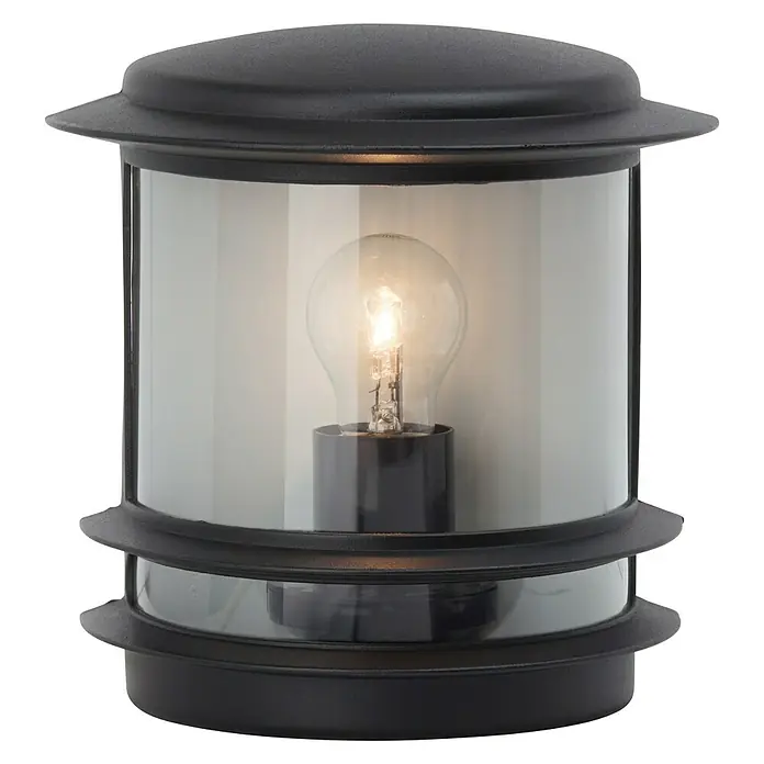 Brilliant Außenwandleuchte Hollywood - 60 W, 13 x 23,5 x 24 cm, Schwarz, IP44 - Nahaufnahme einer schwarzen Außenleuchte mit einem klaren, zylindrischen Lampenschirm und einer Glühbirne im Inneren.