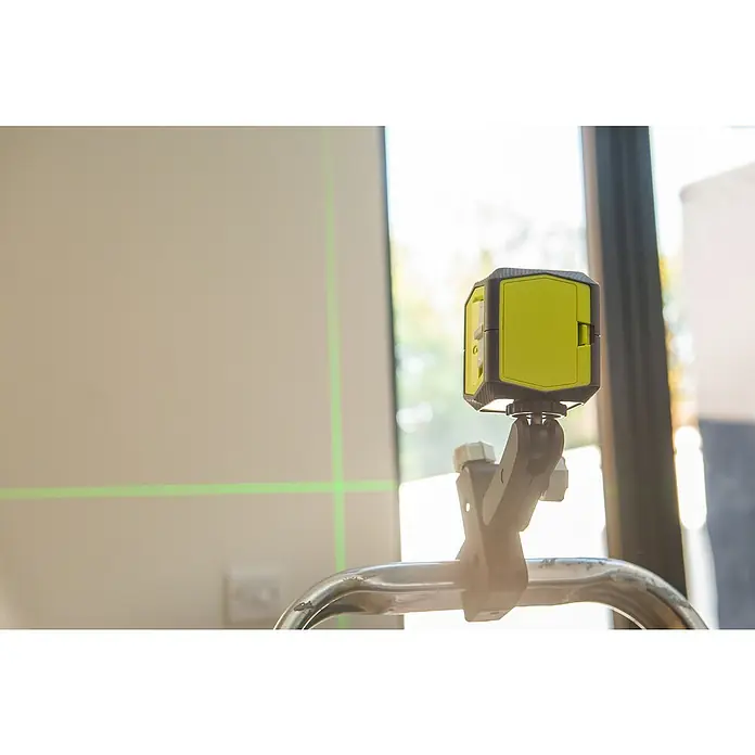 Ryobi Kreuzlinienlaser RBCLLG1 - Max. Arbeitsbereich: 15 m - Eine gelb-schwarze Kreuzlinienlaser-Wasserwaage projiziert grüne Laserlinien an eine Wand, um präzise Ausrichtung und Nivellierung bei Bauarbeiten zu gewährleisten.