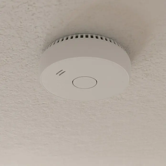 UniTEC Rauchwarnmelder Kriwan/TÜV - Durchmesser: 90 mm, Alarmsignal: 85 dB - Nahaufnahme eines weißen Rauchmelders an einer strukturierten Decke. Wichtig für die Sicherheit im Haus.