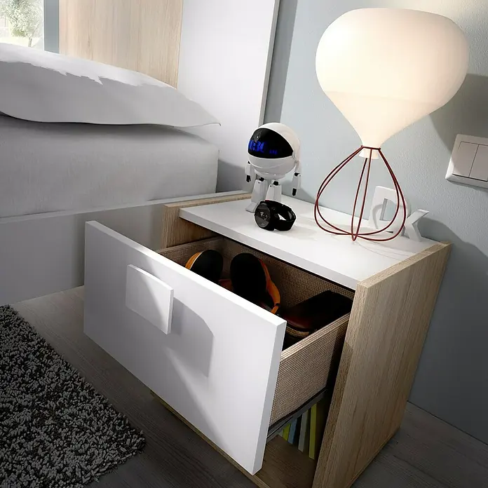 Dekit Mesita de noche Dina - L x An x Al: 33 x 40 x 42 cm, Natural/Blanco, Número de cajones: 1 ud. - Primer plano de una mesita de noche con cajón abierto, lámpara y objetos decorativos, colocada junto a una cama.