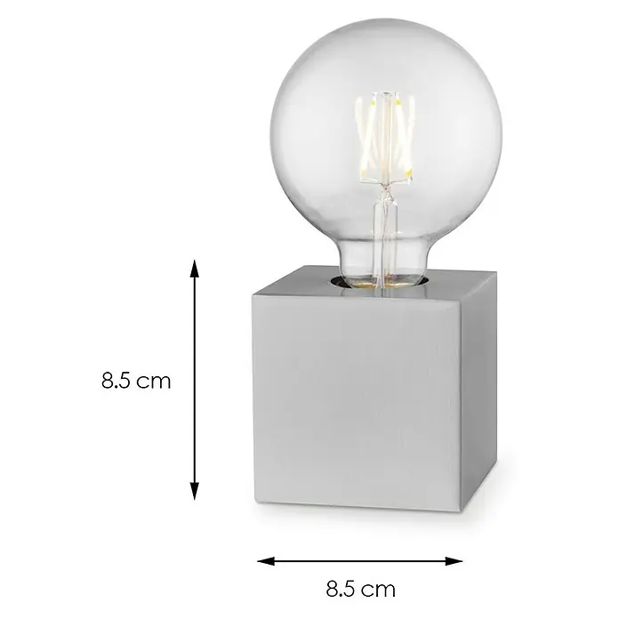 Home Sweet Home Lampenfuß Dry 10 - 10 W, E27, Stahl, Höhe: 8,5 cm - Nahaufnahme einer dekorativen Tischleuchte mit einer würfelförmigen Basis und einer Glühbirne.