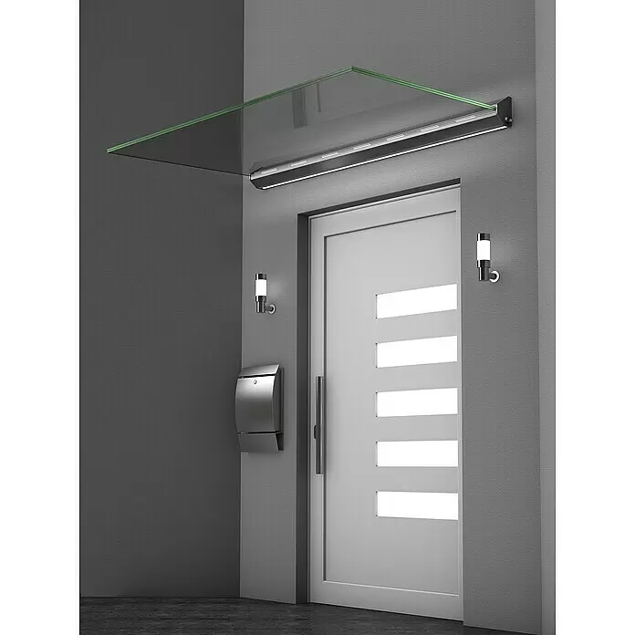 Gutta Vordach LED - 160 x 93,5 x 13,5 cm, Silber, Klarglas - Moderne Glasvordach mit integrierter LED-Beleuchtung über einer weißen Tür, bietet Schutz und Licht für den Eingangsbereich.