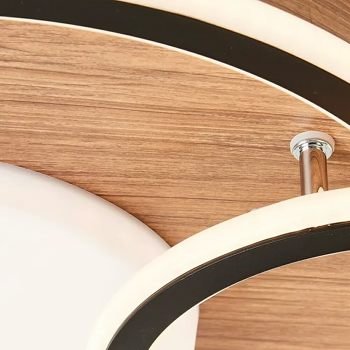 Brilliant LED-Deckenleuchte Karney - 48 W, L x B x H: 57 x 39,4 x 8 cm, Braun, Warmweiß - Nahaufnahme einer modernen Deckenleuchte mit Holzmaserung, LED-Streifen und Chromdetails, die ein elegantes Design und Beleuchtung vereint.