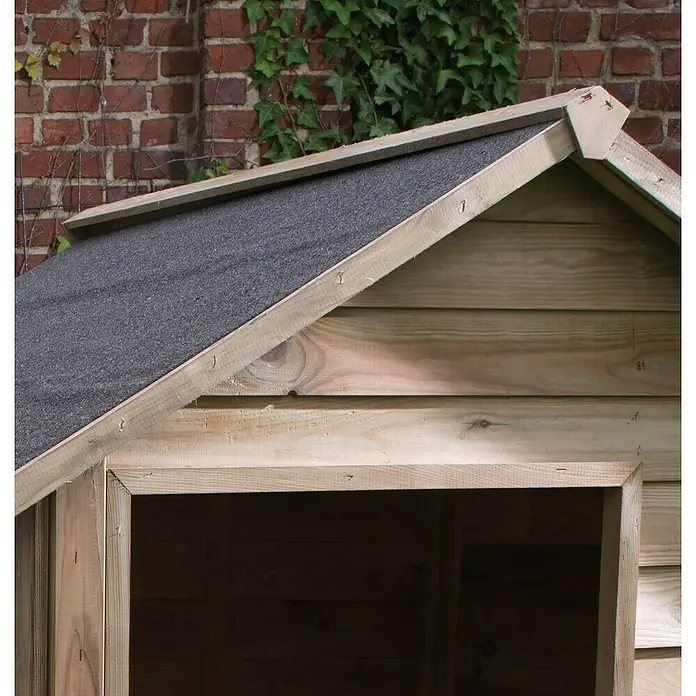 Cerland Caseta para perro Willow M - 114 x 120 x 100 cm, Madera, Natural, 120 x 114 x 100 cm - Primer plano de una casita de madera con un techo de color gris ceniza sobre un fondo de ladrillo rojo con vegetación verde.