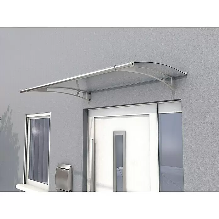 Gutta Pultvordach PT/L - 150 x 95 x 17 cm, Edelstahl, Farbe Dach: Klar - Transparentes Polycarbonat-Vordach mit silberfarbenem Rahmen, über einer modernen weißen Tür montiert.
