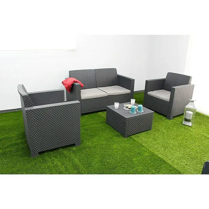 Shaf Conjunto de muebles Evo - 4 pzs., Polipropileno, Antracita - Esta imagen muestra un moderno conjunto de salón hecho de ratán gris sobre un césped verde, que consta de un sofá, sillón y mesa con decoraciones.