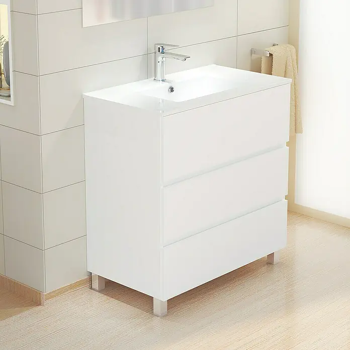 Artysan Mueble bajo de lavabo Patri - 46 x 80 x 85 cm, Blanco mate - Mueble de lavabo blanco con tres cajones y grifo cromado sobre un suelo de baño de color claro.